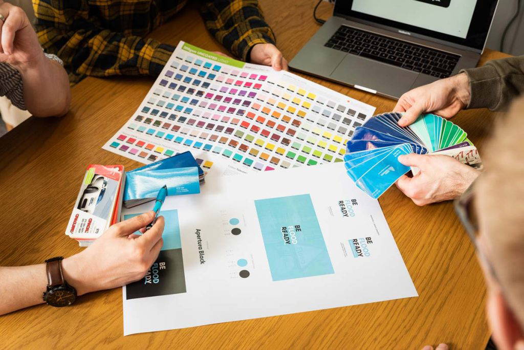 designers looking at colour swatches for branded merchandise stockport