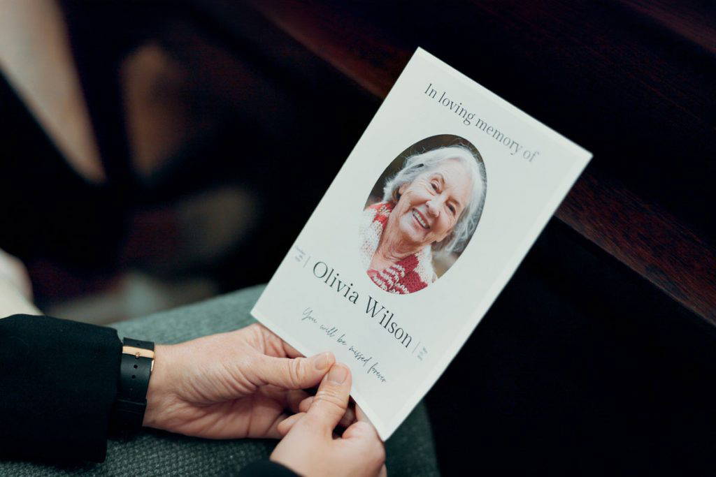 family holding lasting tribute of a funeral programs printing